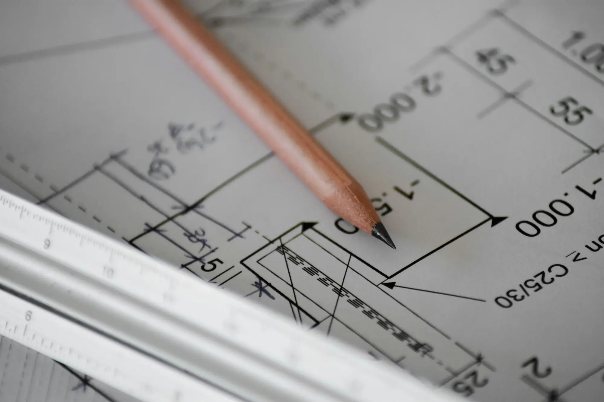 Architectural drawing with a pencil and scale ruler on a desk