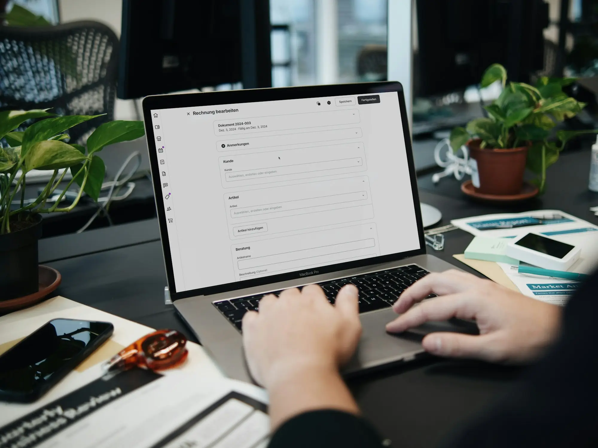 Bookkeeper working through accounts on a laptop at a tidy desk