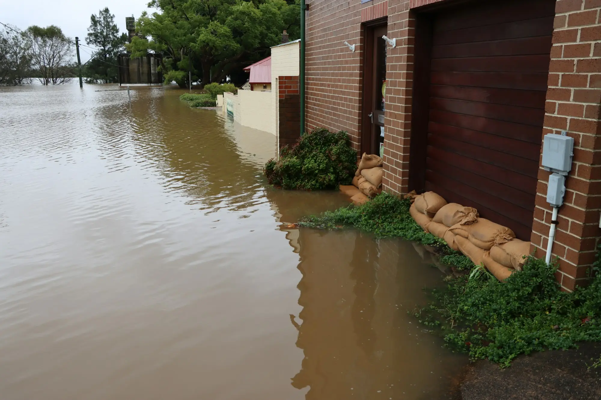 Floodwater surrounding a brick building in Windsor, NSW