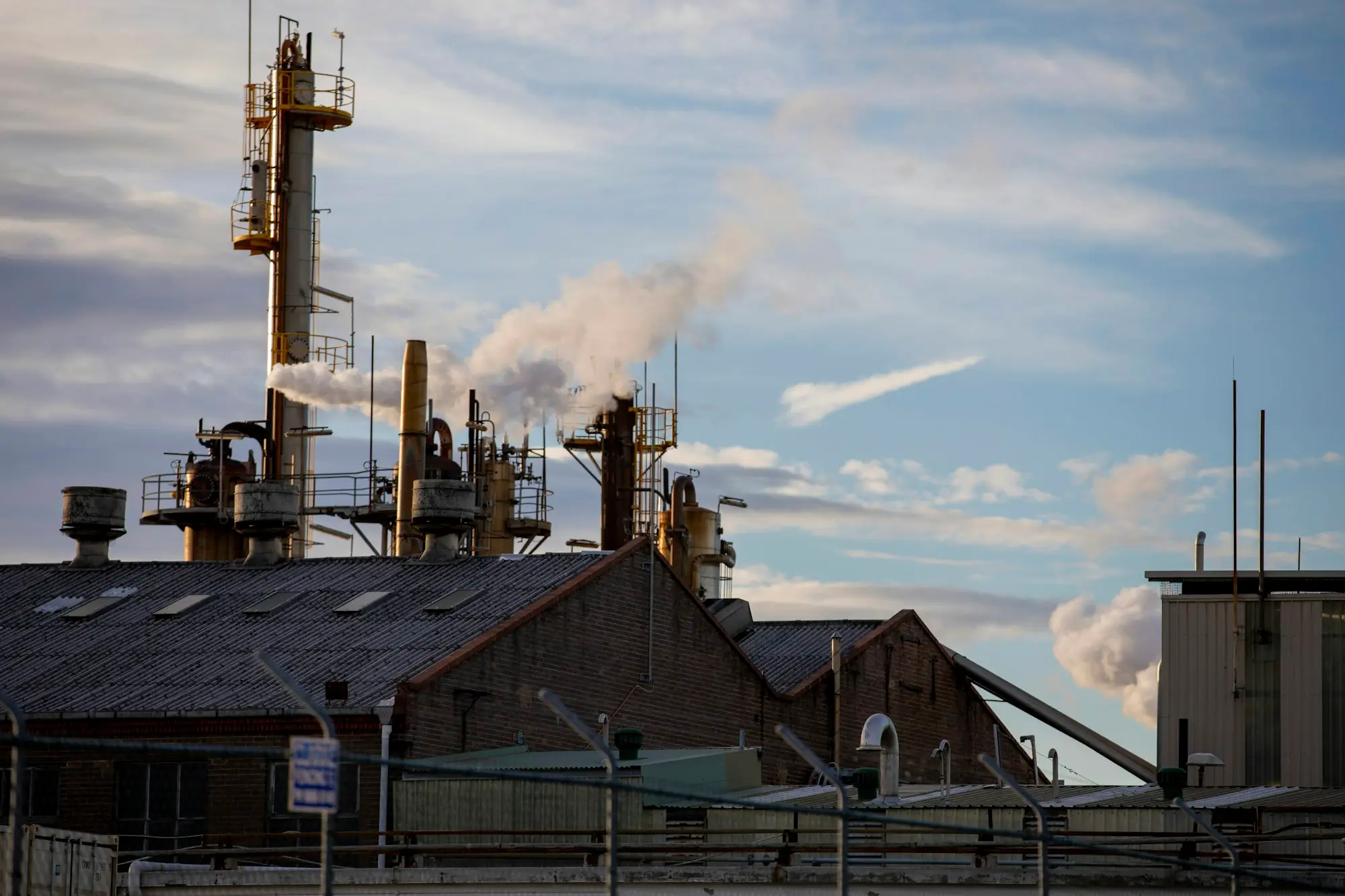Industrial plant with chimneys and sheds on the edge of Sydney