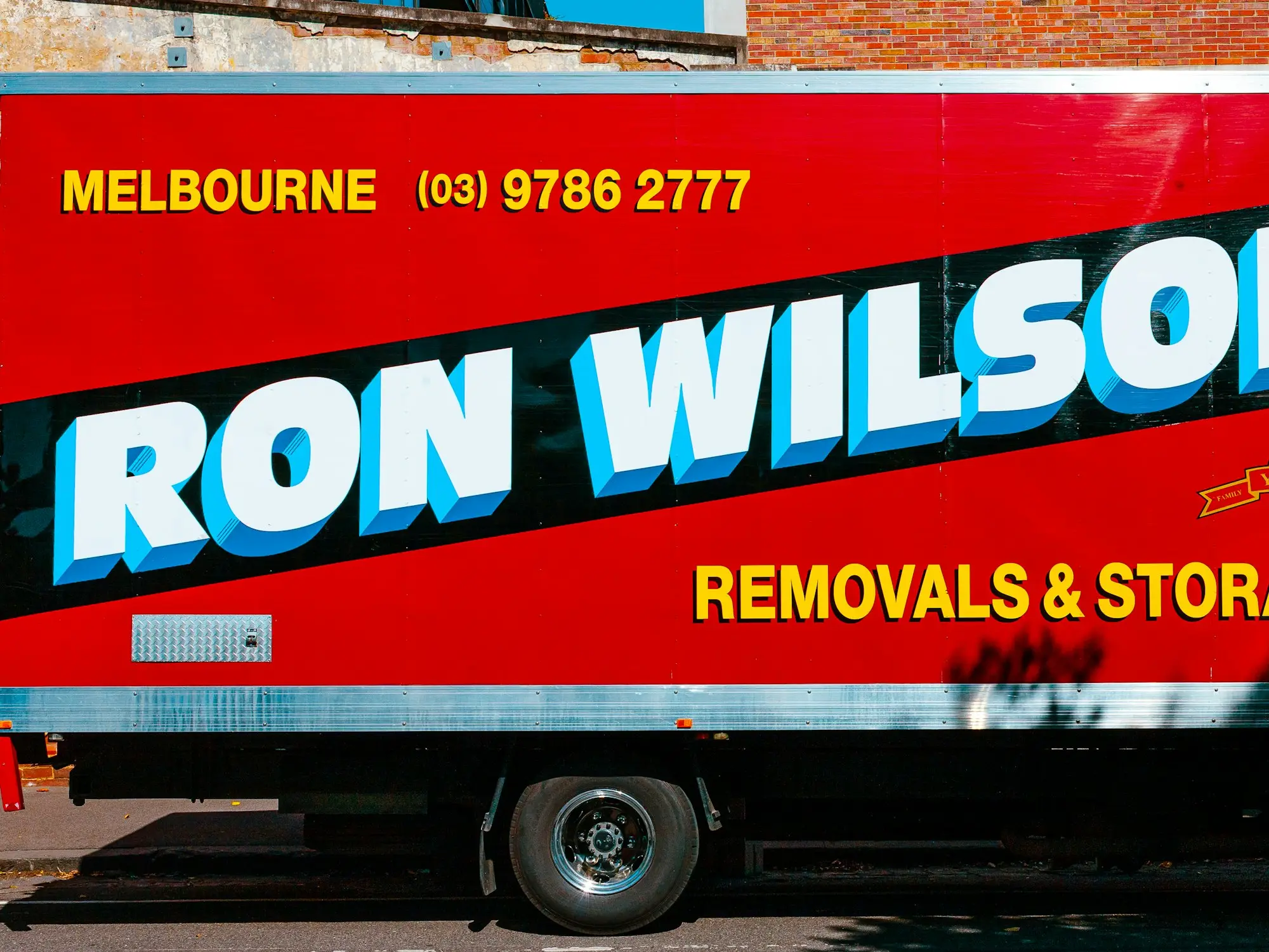 Red removals truck parked on a street in Fitzroy, Melbourne